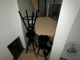 two stools in the corner of a room with a picture on the wall