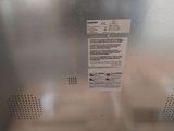 a metal box with a label on it sitting on the floor