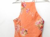 a close up of a dress hanging on a hanger on a wall