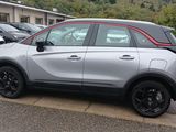 a silver car that is parked on the side of the road