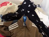 a pile of clothes sitting on top of a bed