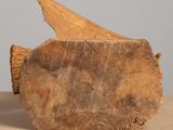 a piece of wood sitting on a table with a piece of wood sticking out of it