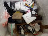 a pile of items in a plastic bag on a bed