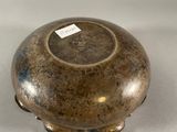 a silver vase sitting on a table with a tag on it