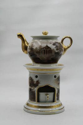 a tea pot on top of a stand with a clock on it