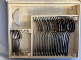 many forks and spoons in a box on the table