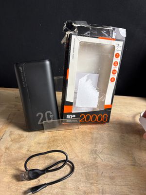 a box of power bank sitting on a table next to a pair of scissors