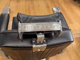 the back end of a black barber chair with a chrome handle