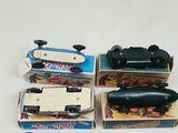 several toy cars are lined up in a row on a white surface