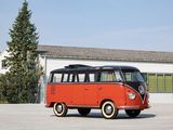 a red and black vw bus parked in front of a building