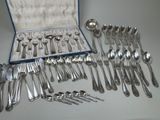 a lot of silver spoons and spoons in a case