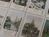 many postcards with asian writing on them on a table