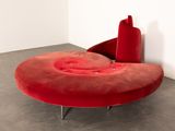 a red chair that is sitting in the corner of a room