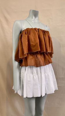 an image of a mannequin wearing a brown and white dress