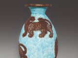 an image of a blue vase with a brown design on it