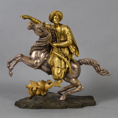 bronze statue of a man on a horse with a bird in his hand
