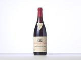 a bottle of red wine sitting on top of a table