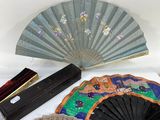 many different types of hand fans on a table