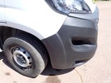 a close up of the front of a van with a flat tire