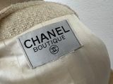 a label on the back of a jacket that says chanel boutique