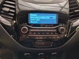 a car dashboard with a radio and a steering wheel