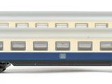 three blue and white train cars sitting side by side on a white surface