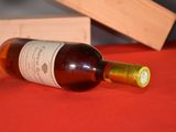 a bottle of wine sitting on a table next to a wooden box