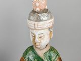 statue of a man with a hat on his head holding a bowl