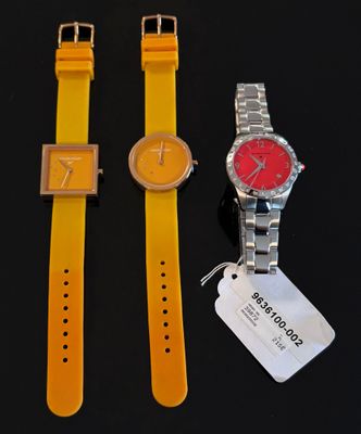 deux montres sont posées l'une à côté de l'autre sur une surface noire