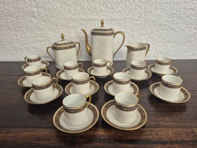 many cups and saucers sitting on a table