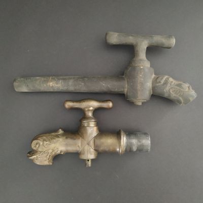 two old faucets that are sitting on a table
