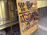 a yellow workbench with a lot of tools on it