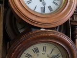 two clocks sitting on top of a box with a clock on it