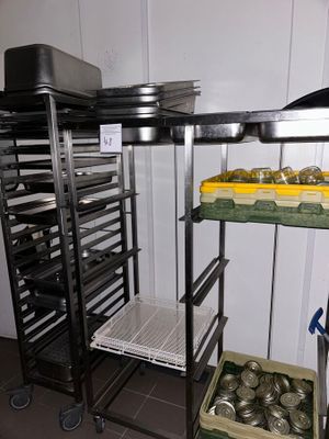 many trays of food sitting on a metal rack