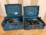 two blue boxes with tools in them sitting on a table