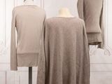 three mannequins with sweaters on display in front of a white wall