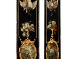 pair of black and gold painted wall plaques with angels and flowers