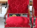 two red chairs sitting next to each other in a room