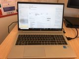 a laptop that is sitting on a desk in front of a monitor
