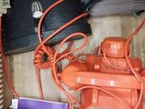 an orange phone in a box with other items