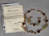 a necklace and bracelet set with a certificate on it
