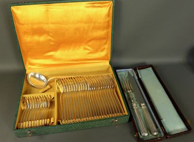 silverware in a green case on a table with other silverware in it