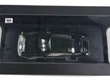the box is open to show the black car in it ' s packaging