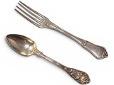 two spoons and a fork on a white background