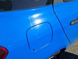 a blue car that is parked on the side of the road