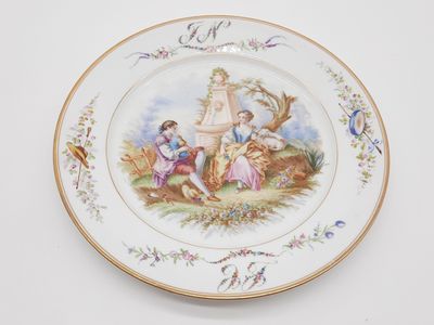 une assiette sur laquelle est représentée une femme et deux enfants
