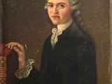 portrait of a man in a black coat holding a book