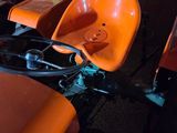 several orange chairs are lined up in a row in a room