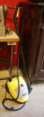 a small sewing machine sitting on a table next to a sewing machine