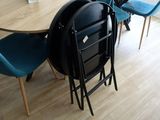 a table and chairs in a room with wood flooring
